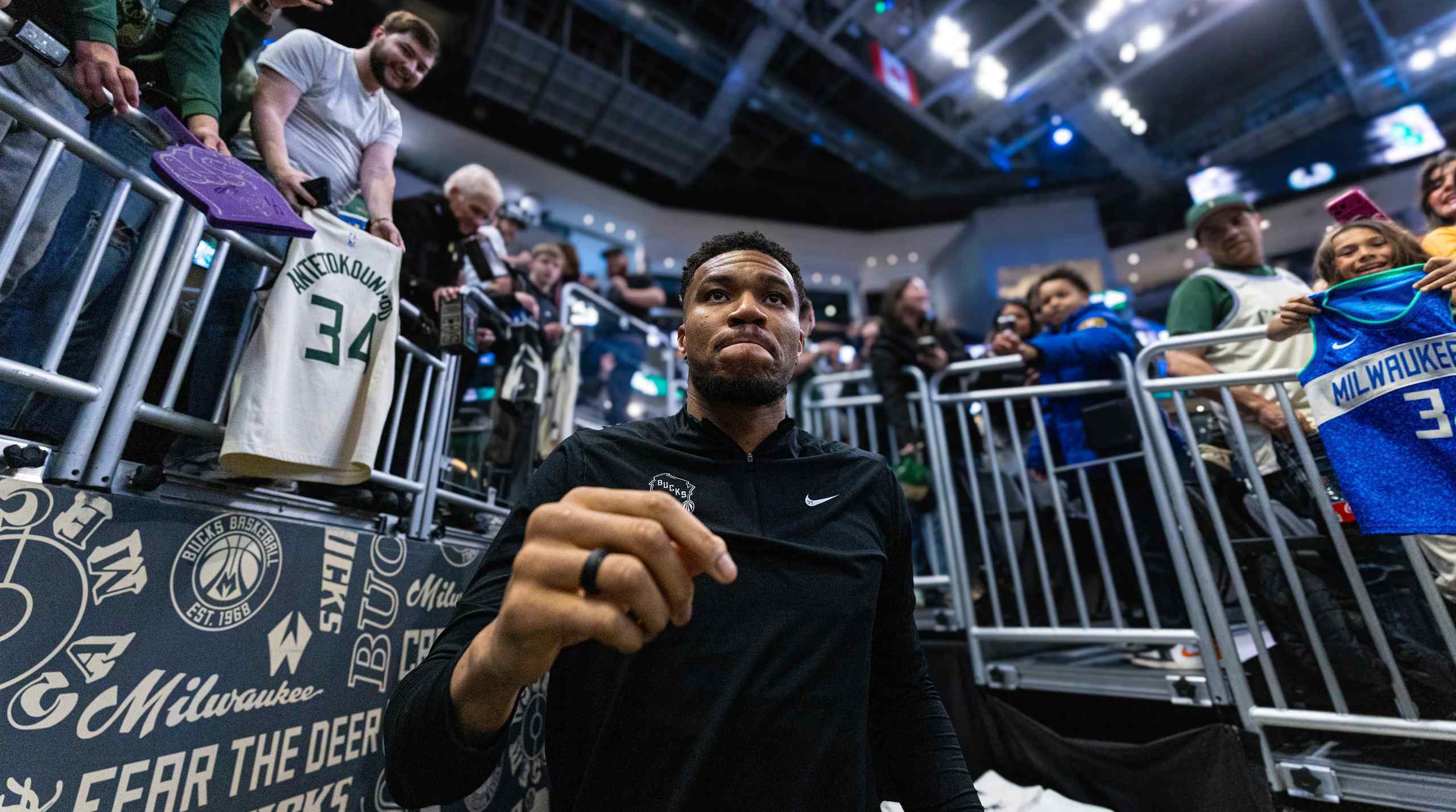 NBA star Giannis Antetokounmpo walking out into a stadium.